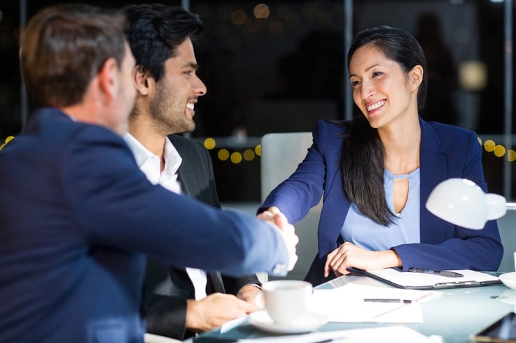 Businessman shaking hands with a colleague in the office.jpeg